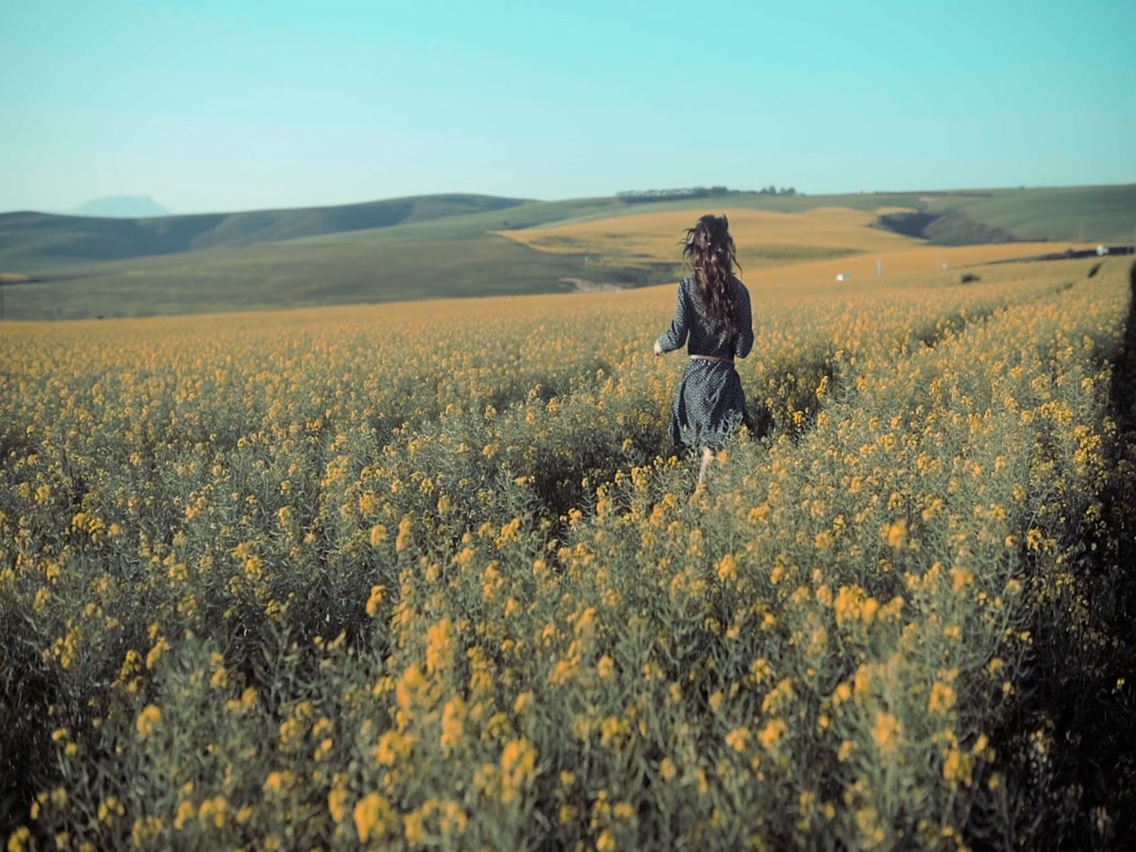 woman-running-flower-field